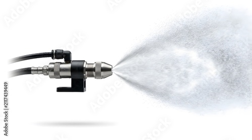 Industrial metal spray nozzle ejecting fine water mist isolated on a plain white background