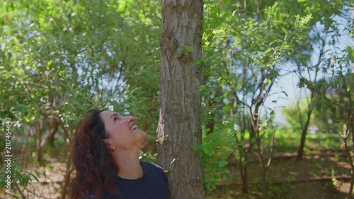 A Moment of Connection: Embracing Nature Through a Serene Encounter with a Tree in a Lush Green Environment