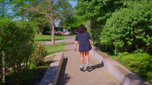 A Roller Skater Enjoys a Bright Day in the Park, Gliding Along Serene Pathways Surrounded by Lush Greenery and Vibrant Nature in High Spirits