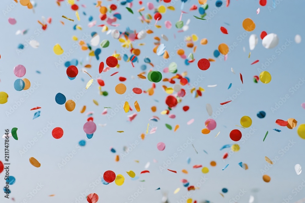 Obraz premium The Confetti Burst Over A Bright Blue Sky Celebrating Colorful Party Moment