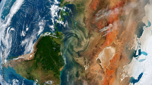 Satellite imagery showing massive dust storm swirling over arid landscape near lush green terrain.