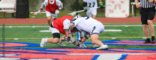 Obraz na plátne Two Lacrosse Players Compete for the Ball During a Faceoff