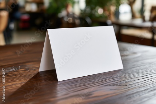 The Blank Tent Card on a Wooden Table in a Cafe Setting