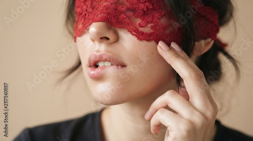 Woman with Red Lace Blindfold Touching Her Face