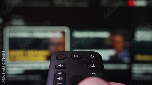 Hand Holding a Remote Control Browses Various Streaming Services On a Large Screen. Person Browsing Streaming Services Using Remote Control and Turn Off smart TV. Internet TV