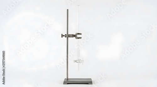 Glass burette mounted on metal stand in laboratory setting