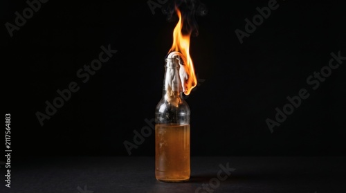Molotov Cocktail Burning Against a Dark Background.