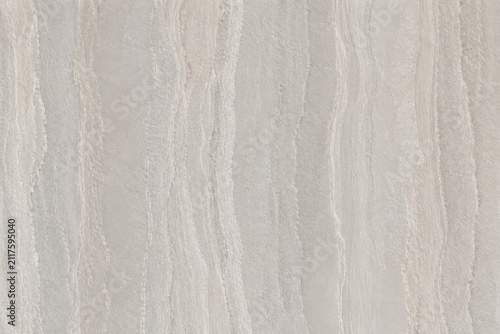 Close up of textured beige and white marble surface with natural wavy patterns during soft studio lighting