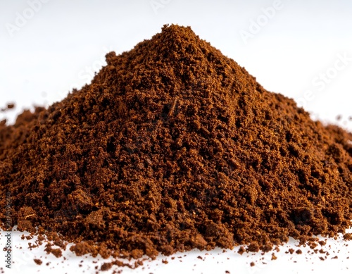 A Conical Pile of Finely Ground Dark Roasted Coffee Beans on White Background