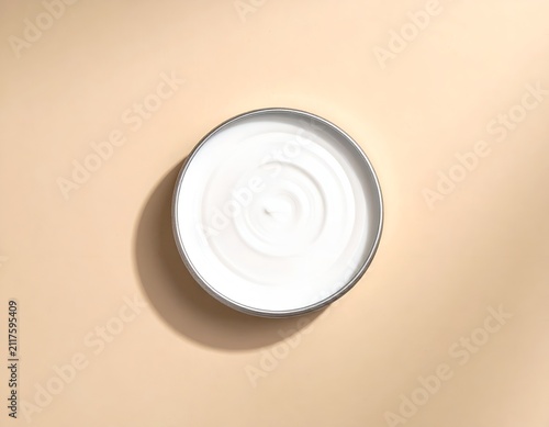 Open Jar of White Cosmetic Cream Seen from Directly Above on Beige Background