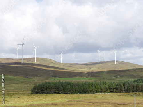 Wind Turbines on Shetland Hills with woodland in foreground. Renewable Energy. Sustainable. UK
