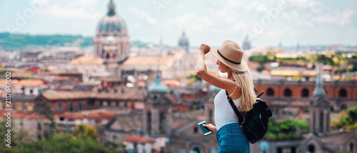 Young Female Tourist with Backpack and Smartphone Enjoying Panoramic View of Rome