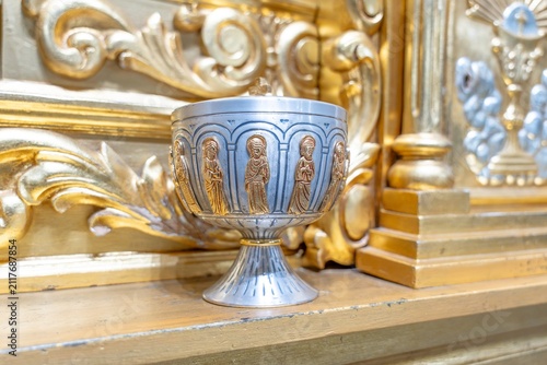 Принти на полотні Ornate religious vessel with figures decorating church altar