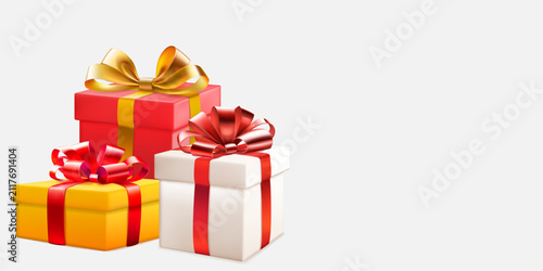 Festive illustration with three colored gift boxes with ribbons and bows on white background