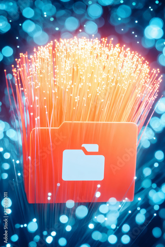 detail cinematic macro image of fiber optic cable cluster glowing intensely, cables guide eye toward radiant blue folder icon while background forms a soft blurred corridor suggesting motion 