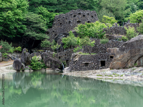 Stone Ruins by a Calm Forest Pond