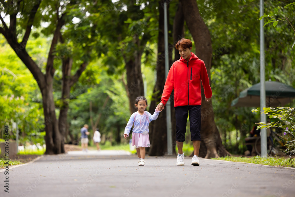 Obraz premium Energy, Asian girl and father running outdoor for child development or growth. Adventure, excited and path with happy kid in nature park for outdoors activity. Healthy outdoor sport for kids.