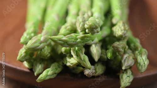 Fresh Green Asparagus Spears on Wooden Plate