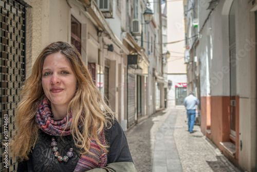 Young woman standing in a narrow street in Coimbra