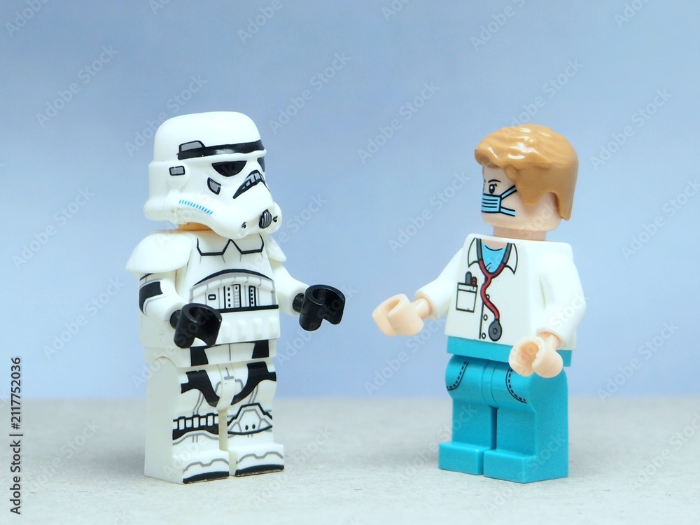 Naklejka premium Indonesia - May 16, 2025 : Mini toy of action figure at table with blurred background. Miniature photography concept design. Minifigure of Stormtrooper and doctor character at hospital clinic.