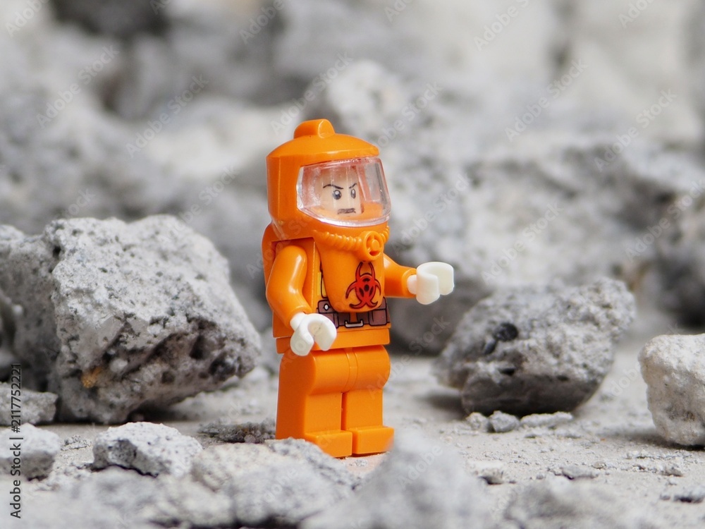 Fototapeta premium Indonesia - May 8, 2025 : Mini toy of action figure at table with blurred background. Miniature photography concept. Hazmat costume conceptual design. Science crew with protection suit.