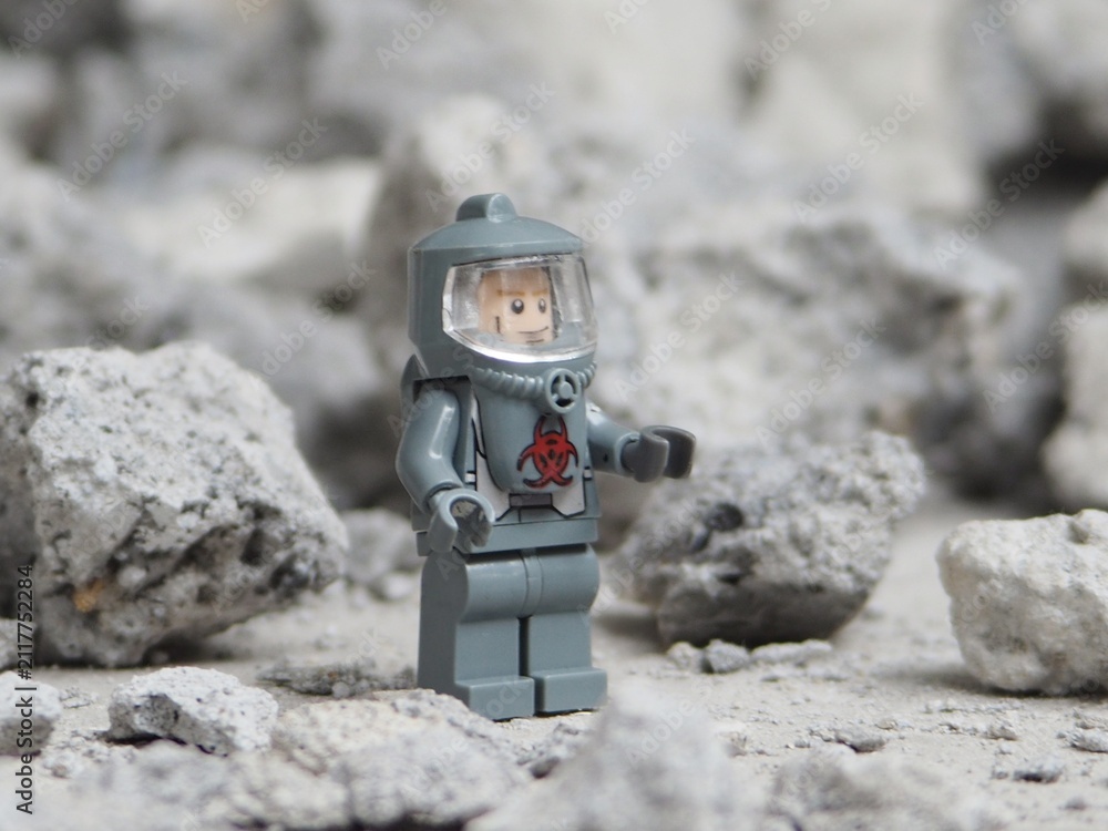 Fototapeta premium Indonesia - May 8, 2025 : Mini toy of action figure at table with blurred background. Miniature photography concept. Hazmat costume conceptual design. Science crew with protection suit.