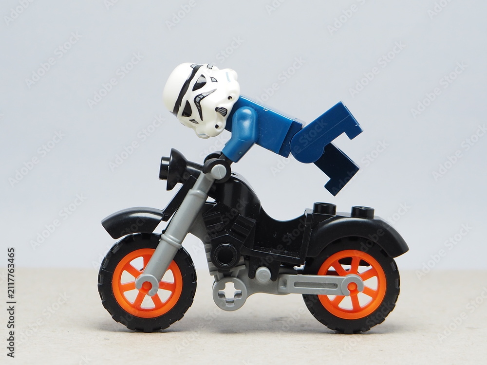 Fototapeta premium Indonesia - December 5, 2025 : Mini toy of action figure at outdoor with blurred background. Miniature photography concept design. Minifigure of freestyler athlete character jumping with motorcycle.