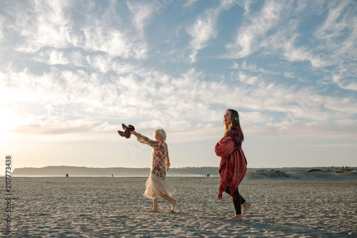Mother and Daughter walk on the beach