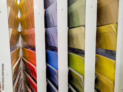 Pastel and bold finish samples stand in organized columns behind clear holders, captured in a close frontal view. The image reflects material selection, remodeling, and personalized home design.