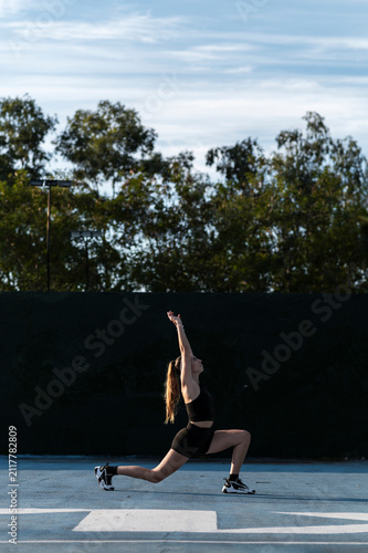 Focused athlete in hip flexor stretch in a kneeling lunge 