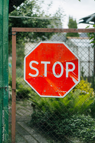 A sign installed in a fenced area.