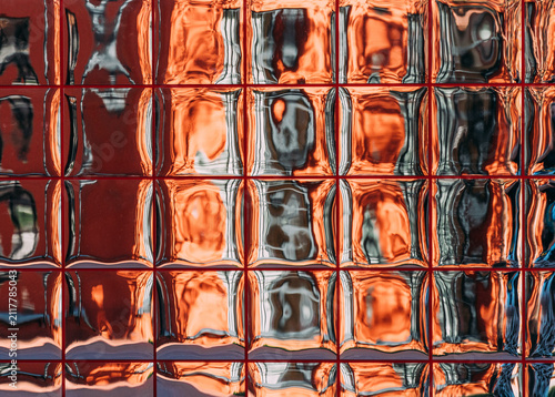 Reflection on a glass surface in a city setting during the day