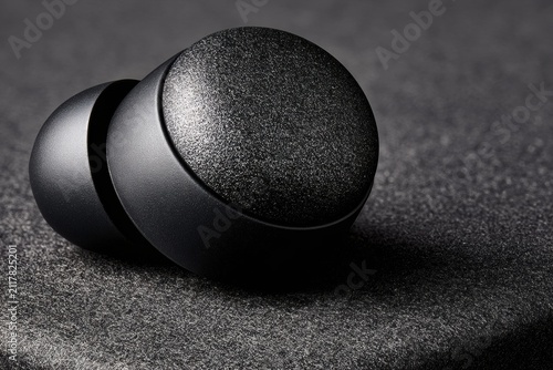 Smart Earpiece in Macro Detail With Faint Coral Glow on Dark Background and Rich Texture Captured in Studio Lighting