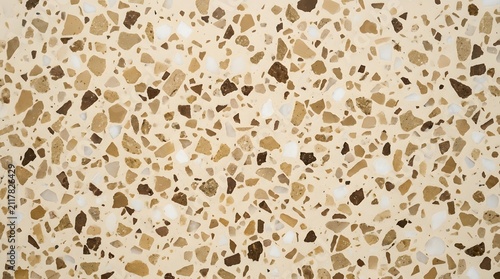 Beige terrazzo texture featuring scattered brown white and tan stone fragments creating a modern seamless architectural surface design for interiors