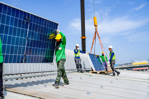 Workers install solar panels on a rooftop in a busy construction site during a clear daytime sky