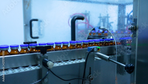vials factory of injections. powder medical drug filling glass vials rotating for packaging in an injection production line in a pharmaceutical manufacturing company medicine making process