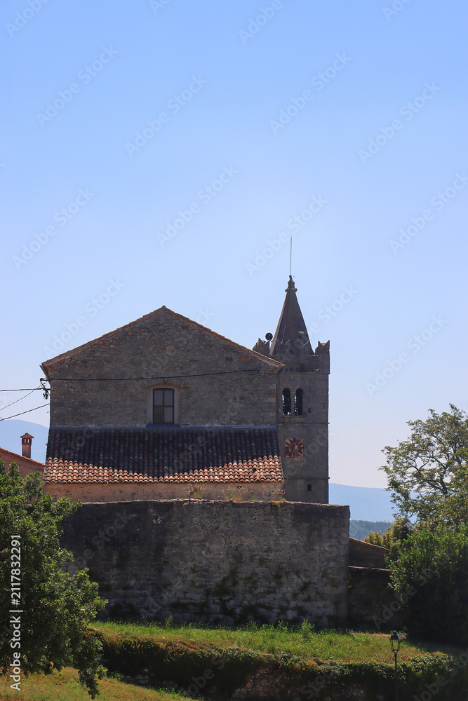 Fototapeta premium Historical architecture and beautiful landscape in the picturesque Mediterranean street in Hum, Croatia. Hum is known as 'smallest town in the world'.
