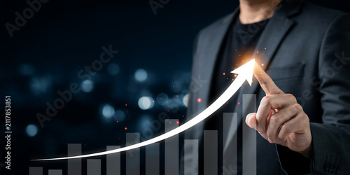 Businessman pointing at rising financial chart to visualize market expansion and profit increase with business investment corporate management strategy analysis development marketing planning