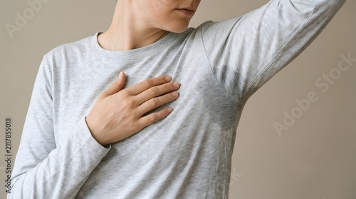 person checking underarm for sweat or body odor
