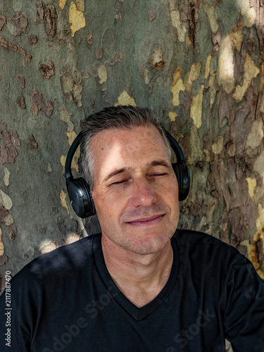 Obraz na plátně Serene portrait of an attractive 50s male practicing mindfulness and relaxation