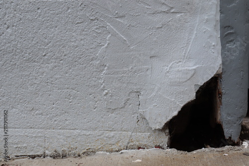 Outdoor old brick wall background. Old house problem and hole in the facade. House renovation and foundation crack. Construction industry and outdoor renovation for old house.