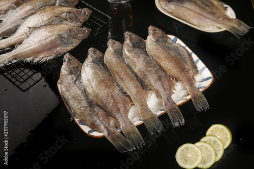 Bild auf Leinwand Fresh Caught Fish Seafood Delicacies from Dalian with Lemon Slices Ready for Coo