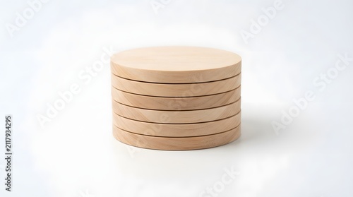 A stack of round wooden coasters isolated on a clean white background for home decor photography