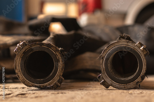 фотографія Dirty fire hoses after a fire with a fire truck in the background