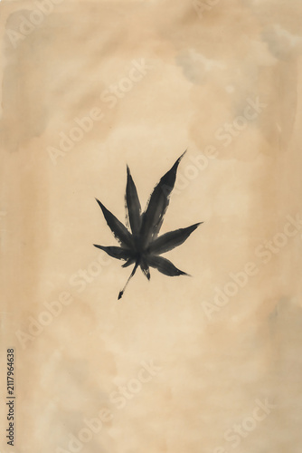 Black cannabis leaf silhouette against neutral background