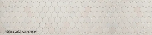Obraz  z motywem Panoramic view of off white ceramic hexagon tiles arranged in a repetitive geometric pattern