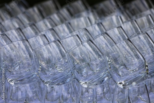 Many empty clean glasses on mirror surface. Close up.