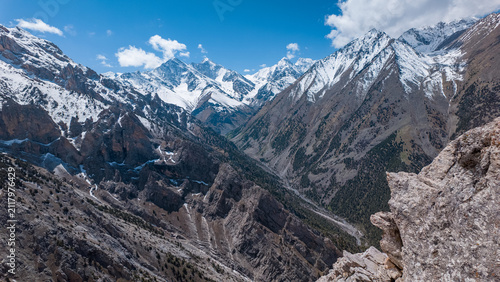 Stunning views of the Pamir mountain range in Kyrgyzstan reveal dramatic gorges and towering peaks. This breathtaking landscape beckons trekkers and mountaineers to explore its natural beauty.