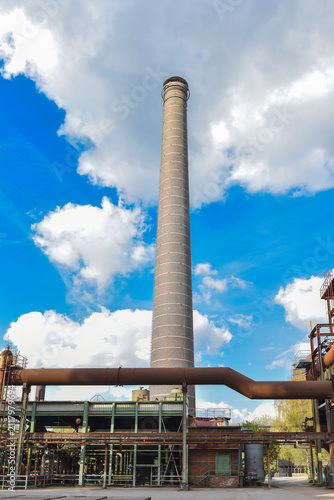 Abandoned brick factory with a smokestack. Empty, ruined workshop