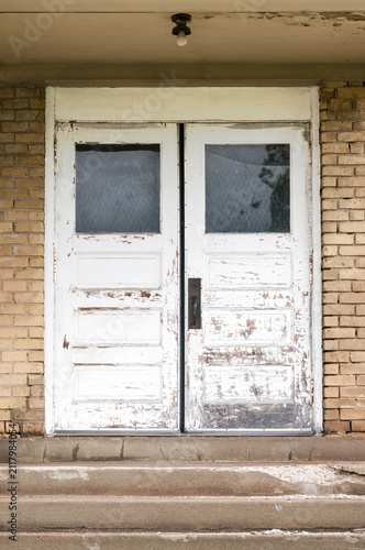 Old White Double Doors at Top of Concrete Stairs